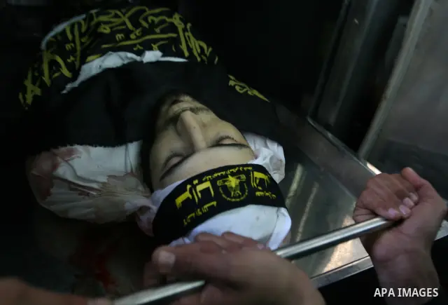 Relatives gather next to the body of Islamic Jihad militant Khaled Shalan at the morgue of Kamal Edwan hospital in Beit Lahiya, northern Gaza Strip, Thursday, March 5, 2009. An Israeli air strike in the Gaza Strip Thursd...