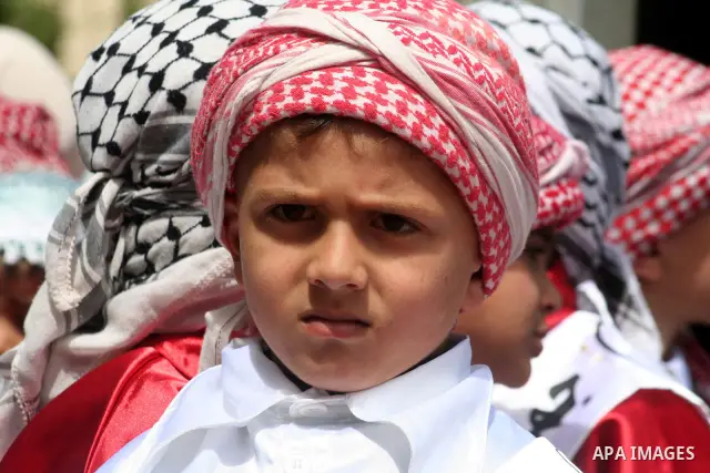 Palestinian children wear Kefiyeh, traditional Arab scarf, during a rally in Gaza City to mark the Palestinian children day on April 05, 2009. Former international prosecutor Richard Goldstone will lead a broadened human...