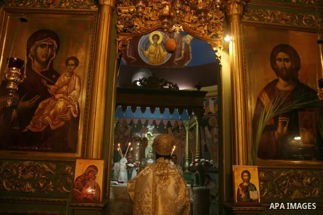 Palestinian Christian Orthodox worshippers celebrate a Palm Sunday mass in Gaza City on April 12, 2009. As Western Christians mark marked Easter Sunday, Orthodox churches were celebrating Palm Sunday, a week ahead of the...