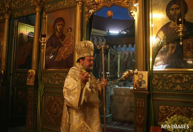 Palestinian Christian Orthodox worshippers celebrate a Palm Sunday mass in Gaza City on April 12, 2009. As Western Christians mark marked Easter Sunday, Orthodox churches were celebrating Palm Sunday, a week ahead of the...