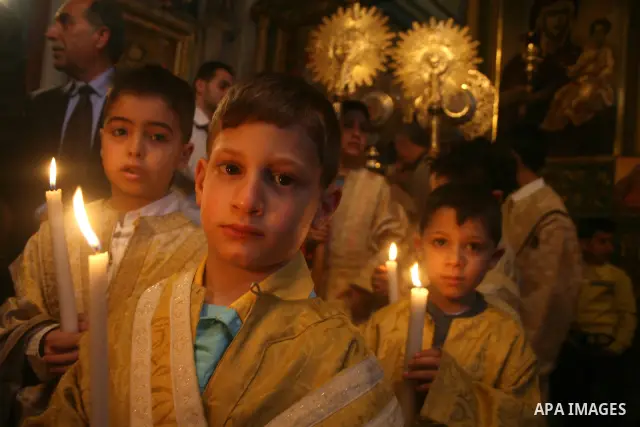 Palestinian Christian Orthodox worshippers celebrate a Palm Sunday mass in Gaza City on April 12, 2009. As Western Christians mark marked Easter Sunday, Orthodox churches were celebrating Palm Sunday, a week ahead of the...