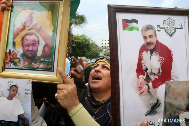 Palestinians shout slogans during a rally calling for the release of Palestinian prisoners from Israeli jails in Gaza City on April 16, 2009 ahead of the Palestinian Prisoner Day. On March 17 Palestinians mark Prisoner D...
