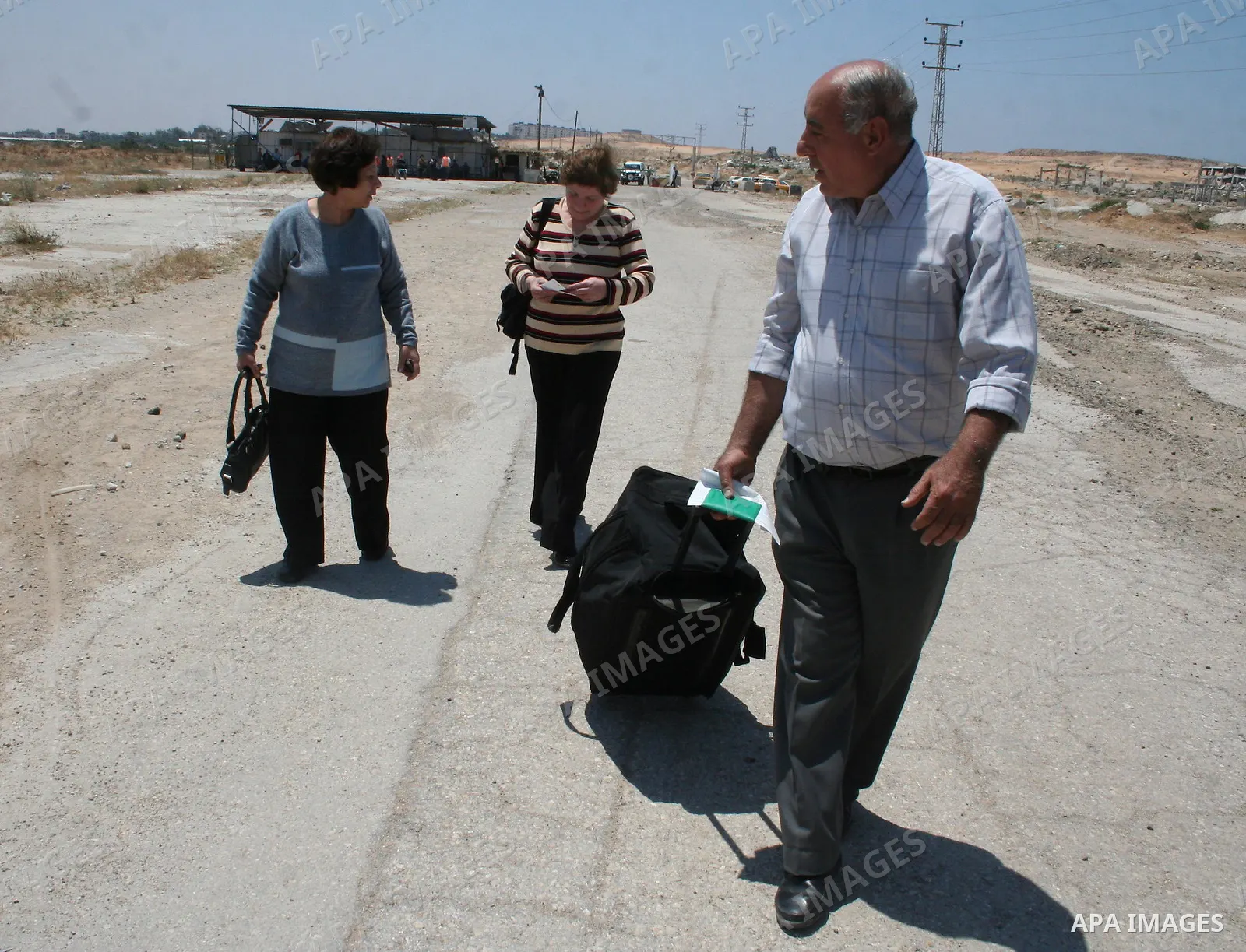 Palestinian Christians walk towards Erez crossing in the northern Gaza Strip on May 11, 2009 after Israel granted 95 permits for Christians from the isolated and impoverished territory to travel to the West Bank town of...