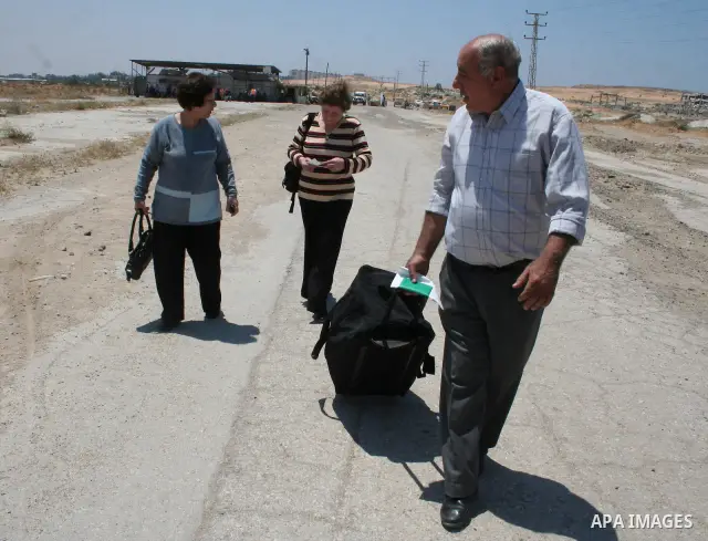 Palestinian Christians walk towards Erez crossing in the northern Gaza Strip on May 11, 2009 after Israel granted 95 permits for Christians from the isolated and impoverished territory to travel to the West Bank town of...
