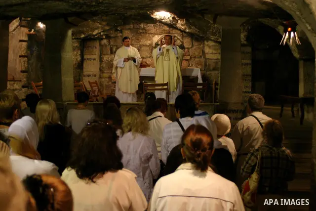 Christian worshippers pray inside the Church of the Nativity, traditionally believed to be the birthplace of Jesus Christ, in the West Bank city of Bethlehem, on May 11, 2009, two days before the historic visit of the Po...