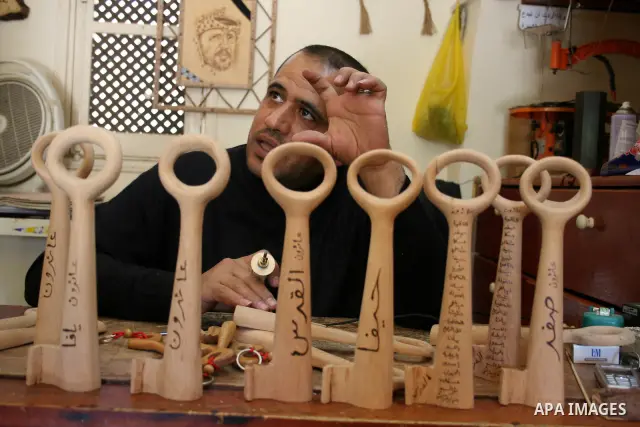 A Palestinian souvenirs maker makes a wooden key with the names of the villages and cities of the old Palestine at his shop in Gaza city, May 13, 2009. On Thursday, the Palestinians will mark their Nakba day, or the cata...
