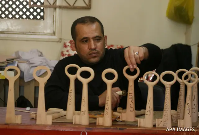 A Palestinian souvenirs maker makes a wooden key with the names of the villages and cities of the old Palestine at his shop in Gaza city, May 13, 2009. On Thursday, the Palestinians will mark their Nakba day, or the cata...
