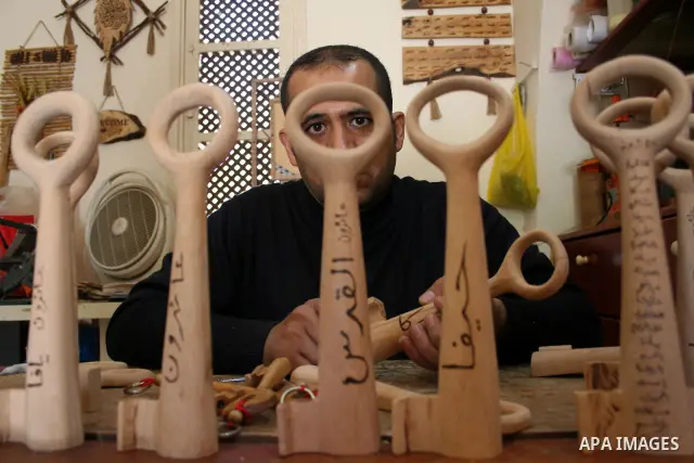 A Palestinian souvenirs maker makes a wooden key with the names of the villages and cities of the old Palestine at his shop in Gaza city, May 13, 2009. On Thursday, the Palestinians will mark their Nakba day, or the cata...