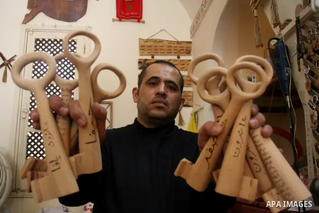 A Palestinian souvenirs maker makes a wooden key with the names of the villages and cities of the old Palestine at his shop in Gaza city, May 13, 2009. On Thursday, the Palestinians will mark their Nakba day, or the cata...