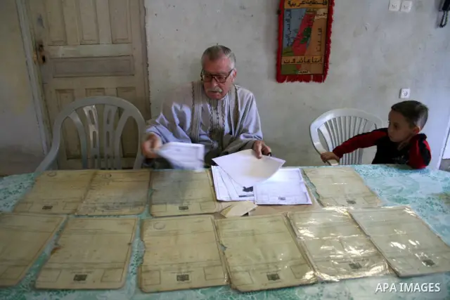 An elderly palestinian refugee Abu Marwan El-Khaldi ,80,displays his lost house ownership documents and his home Key inside 48 lands, in Gaza City. Palestinian refugees still dream to come back to their houses inside the...