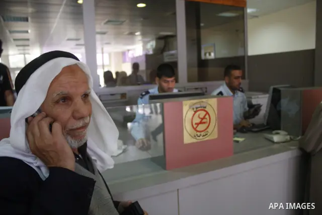 A Palestinian border official drops a bunch of passports belonging to passengers authorised to travel to Egypt, at the Rafah border point in the southern Gaza Strip on May 16, 2009. Egypt opened its border with Gaza to t...