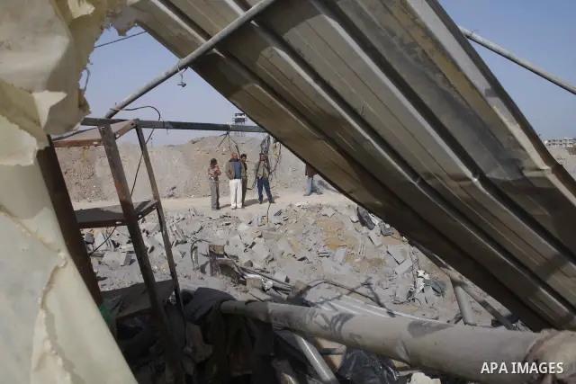 Palestinian men inspect the damaged smuggling tunnel linking the southern Gaza Strip town of Rafah with Egypt following an overnight Israeli air strike in Gaza Strip, May 20, 2009. Israeli warplanes on Tuesday night carr...
