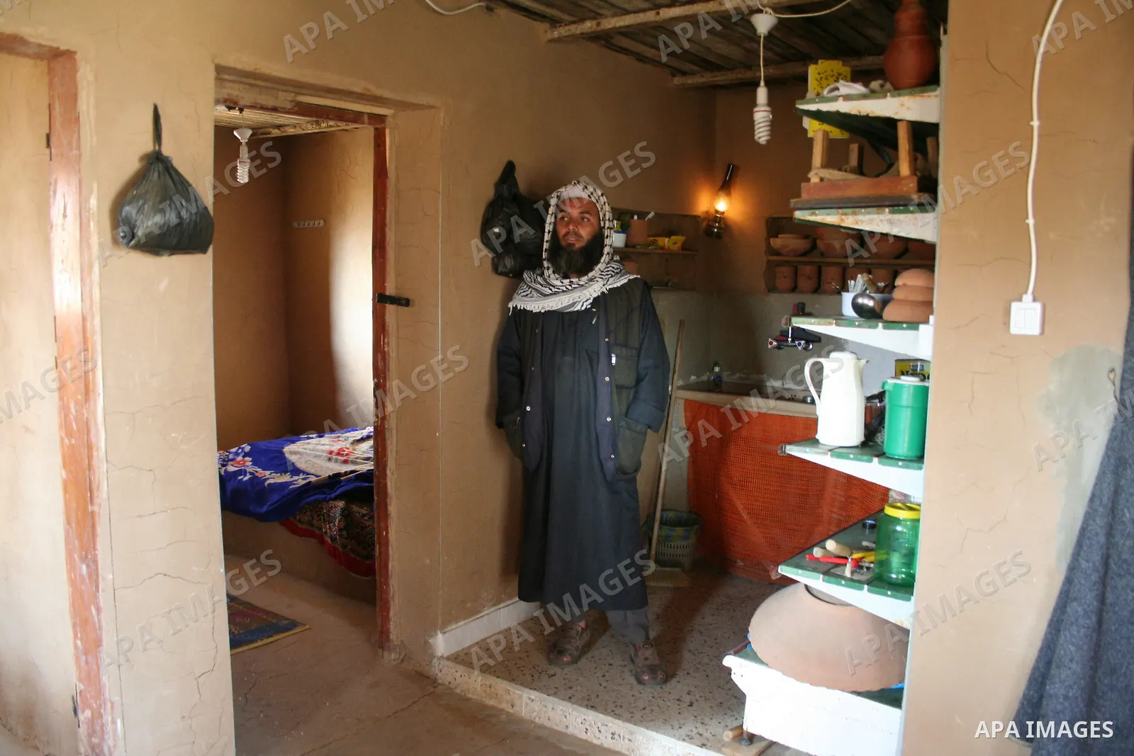 Palestinian Jihad al-Shaer, whose family home was destroyed during the last Israeli war on Gaza, stand in his new mud house in the southern Gaza Strip refugee camp of Rafah on May 24, 2009. the new mud house of jihad al-...