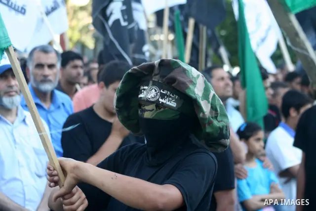 A masked member of Hamas's armed wing, the Ezzedine Al-Qassam Brigades, takes part in a demonstration in Gaza city on May 31, 2009 in protest against an attempt to arrest a senior Hamas commander in the West Bank town of...