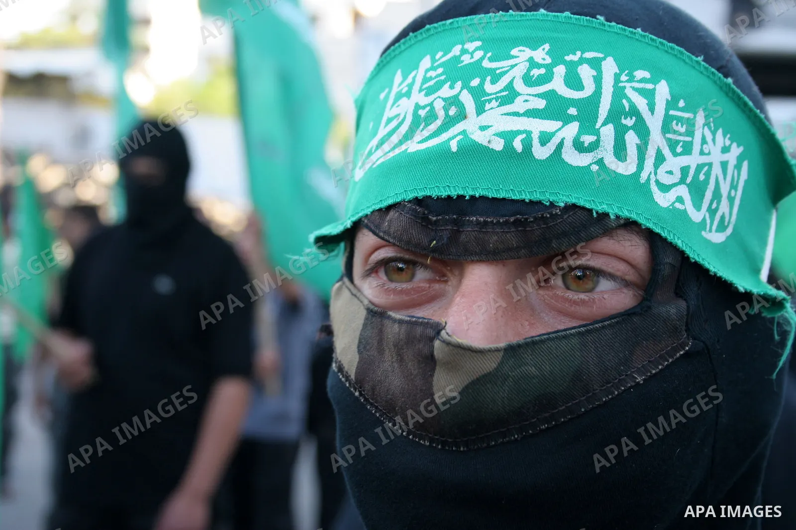 A masked member of Hamas's armed wing, the Ezzedine Al-Qassam Brigades, takes part in a demonstration in Gaza city on May 31, 2009 in protest against an attempt to arrest a senior Hamas commander in the West Bank town of...