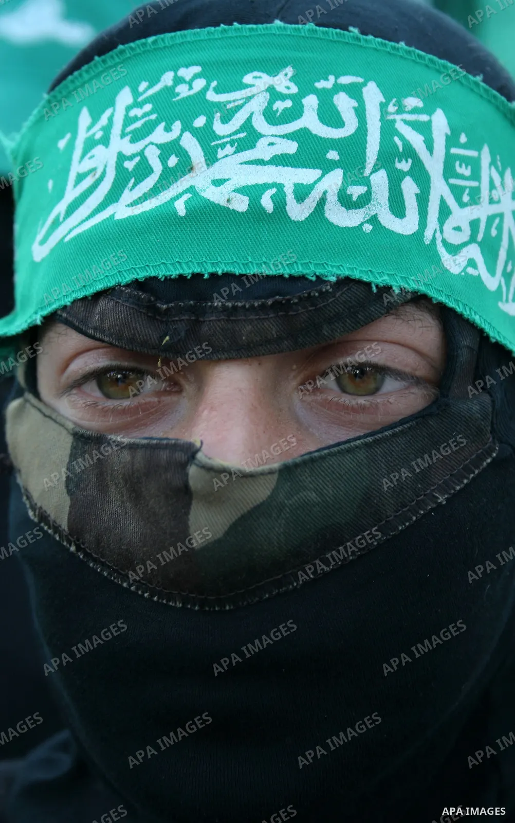 A masked member of Hamas's armed wing, the Ezzedine Al-Qassam Brigades, takes part in a demonstration in Gaza city on May 31, 2009 in protest against an attempt to arrest a senior Hamas commander in the West Bank town of...