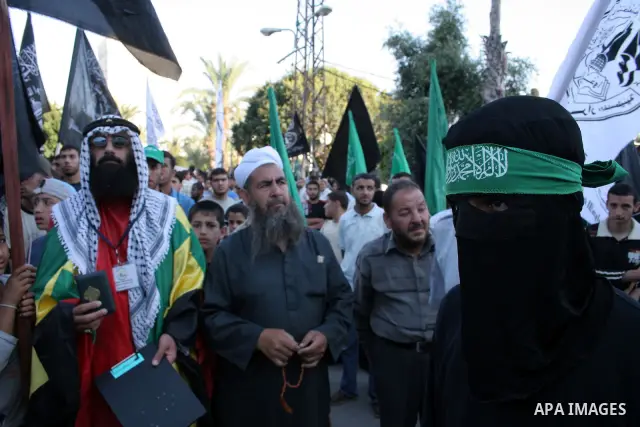 A masked member of Hamas's armed wing, the Ezzedine Al-Qassam Brigades, takes part in a demonstration in Gaza city on May 31, 2009 in protest against an attempt to arrest a senior Hamas commander in the West Bank town of...