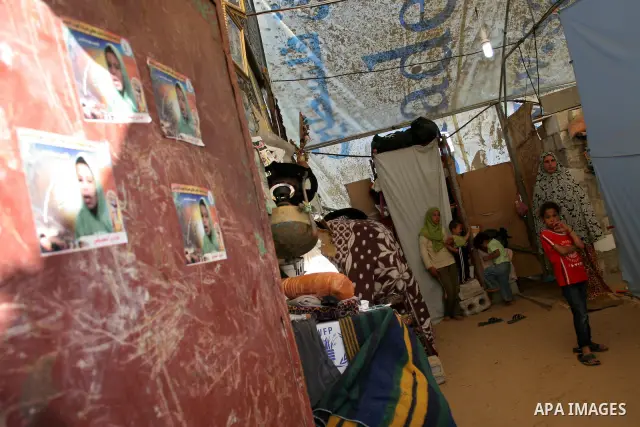 Palestinian stands in a makeshift hut after her family's house was destroyed during Israel's offensive in the Gaza Strip earlier this year, in al-Zaitoun neighbourhood of Gaza City on June 2, 2009. Twenty-nine members of...