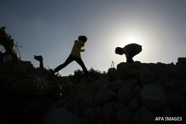 Palestinian children from al-Samoni family play atop the rubble of their house that was destroyed during Israel's offensive in the Gaza Strip earlier this year, in al-Zaitoun neighbourhood of Gaza City on June 2, 2009. T...