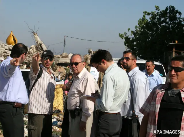 UN lead investigator Richard Goldstone (C) and members of his delegation inspect the destruction at the Samoni family home in Gaza City on June 03, 2009. Twenty-nine members of the extended family were killed during the...