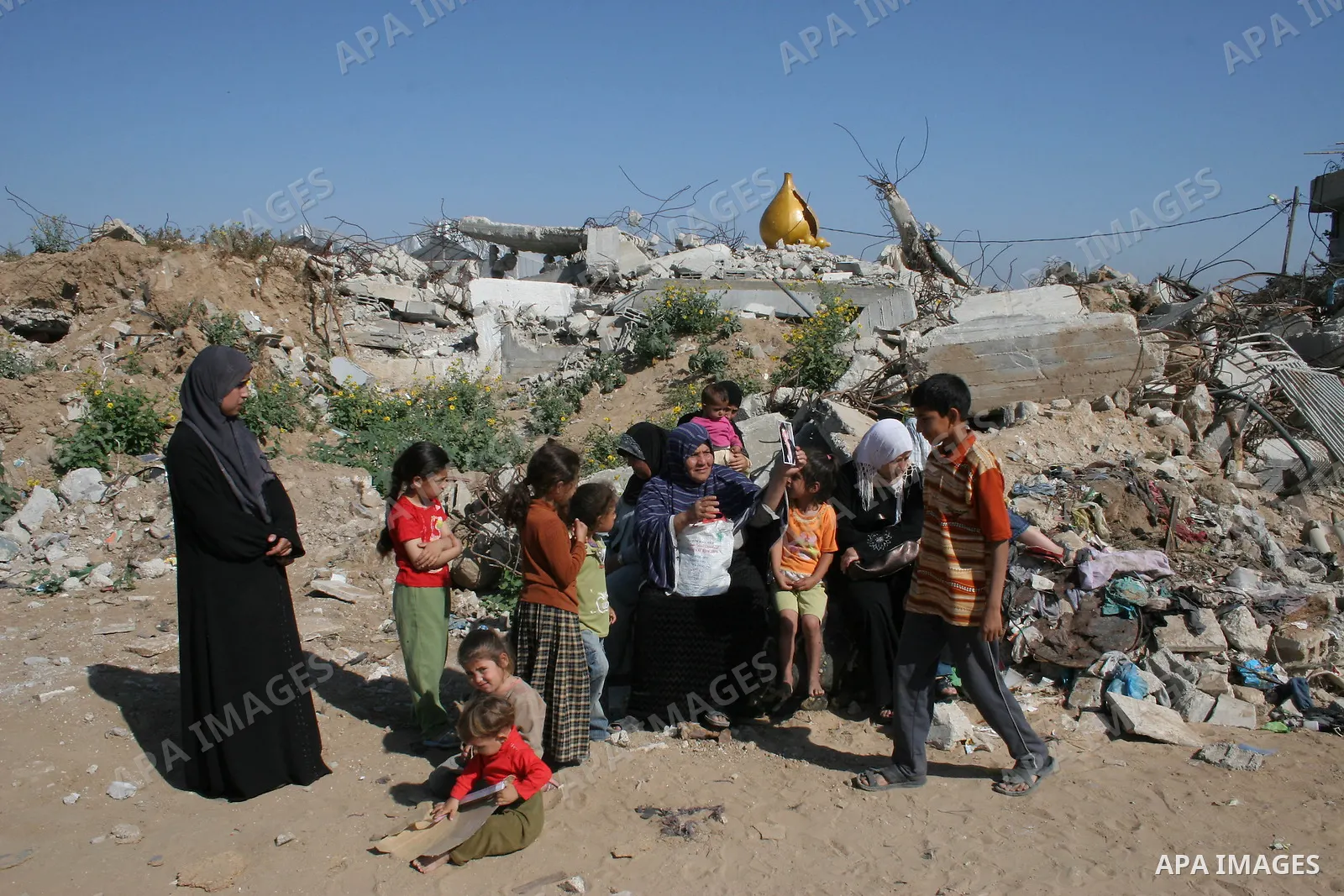 A Palestinian woman holds up a portrait of her son Nedal, one of 29 members of the Samuni family killed during Israel's "Operation Cast Lead", as UN lead investigator Richard Goldstone and members of his delegation arriv...
