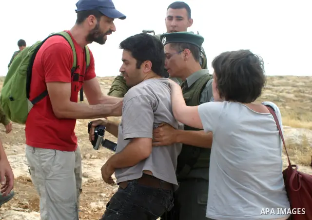 Israeli soldiers and border police clash with Israeli and Palestinian activists during a demonstration against settlements near Sousia in the southern West Bank, south of Hebron on Saturday June 06, 2009. Photo Najeh Has...