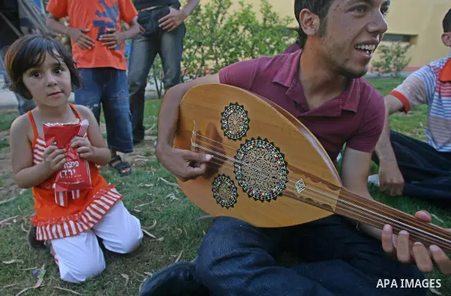 A Palestinians play on guitar at Al-Qattan Culture Center, in Gaza City on June 11, 2009. PHOTO/Thaer Mahmoud
