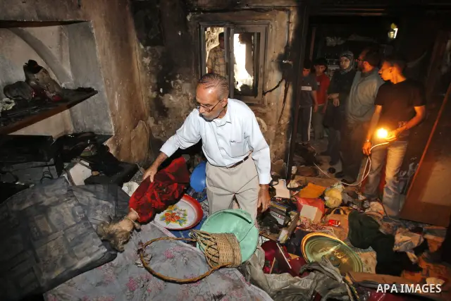A relative of Palestinian Yahya al-Ghbar inspects a room at the latter's house after Israeli soldiers allegedly raided and set fire on it in the West Bank city of Nablus on June 18, 2009. Witnesses reported that Israeli...