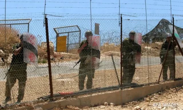 A Palestinian protesters clash with Israeli soldiers during a demonstration against Israel's controversial separation barrier in the West Bank village of Bilin, near Ramallah on June 19, 2009. Photo by Nedal Shtieh
