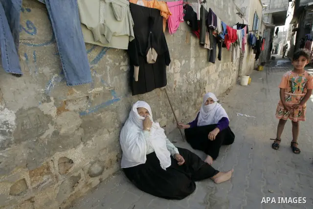 A Elderly refugees Women sit in the street in the Rafah refugee camp southern Gaza Strip on 20 June 2009, the World Refugees Day. Palestinians around the world commemorate their displacement in 1948 as the world marks Wo...