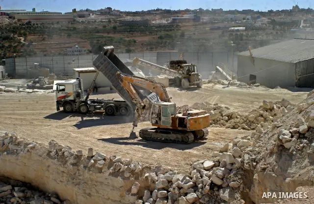 Palestinian laborers work at a quarry in the West Bank village of Bein Nea`am near Hebron on June 21, 2009. Stone and marble factories and quarries, located mainly in the West Bank cities of Hebron and Bethlehem, are at...
