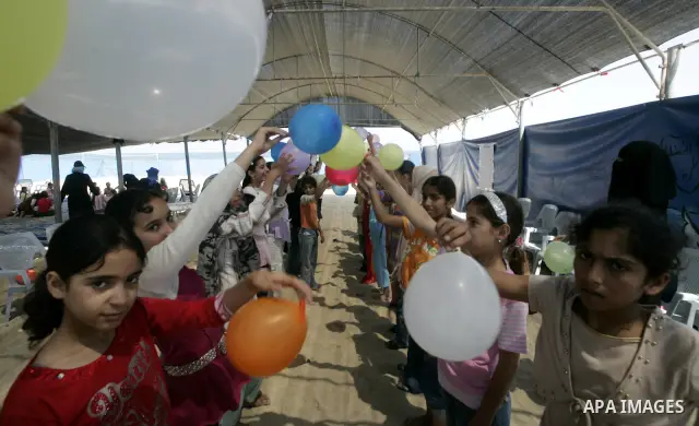 Palestinian girls play with balloons during a summer camp at the beach of Rafah in the southern Gaza Strip on June 21, 2009. The camp was organized by the United Nations Relief and Works Agency (UNRWA). PHOTO by Abed Rah...