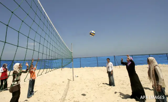 Palestinian girls play volley ball during a summer camp at the beach of Rafah in the southern Gaza Strip on June 21, 2009. The camp was organized by the United Nations Relief and Works Agency (UNRWA). PHOTO by Abed Rahim...
