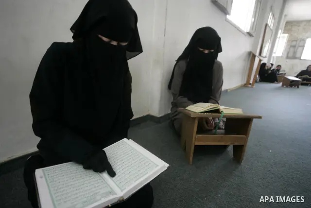 A Palestinian girls read the Koran at a mosque in Rafah, southern Gaza Strip on June 23, 2009. The Palestinian Islamist movement Hamas launched summer camps for the study of the Koran, drawing a broad participation from...