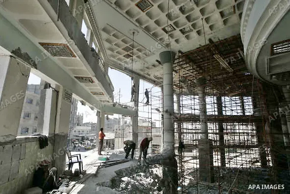 A Palestinian workers pull down a mosque ceilings to repair it, destroyed during Israel's 22-day offensive over Gaza, in Rafah, southern Gaza Strip on June 30, 2009. A report by The International Committee of the Red Cro...