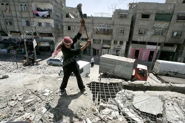 A Palestinian workers pull down a mosque ceilings to repair it, destroyed during Israel's 22-day offensive over Gaza, in Rafah, southern Gaza Strip on June 30, 2009. A report by The International Committee of the Red Cro...
