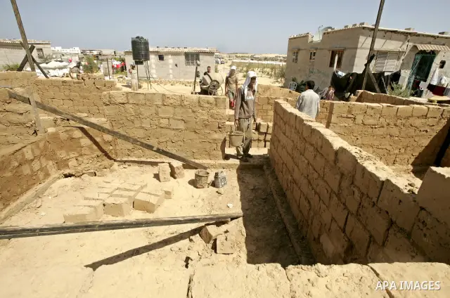 Palestinian workers prepare blocks of clay for the construction of clay houses to replace houses destroyed in Israel's last military operation in Gaza, in Rafah, southern Gaza Strip on July 02 2009. Many parts of the Ham...