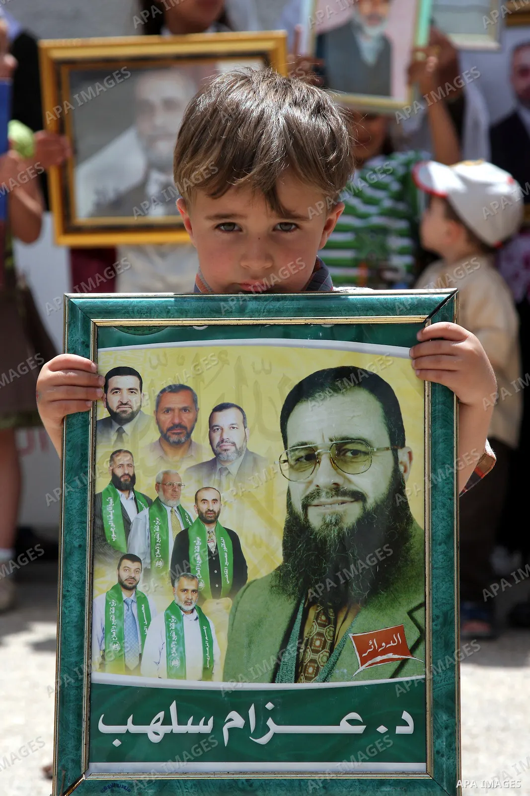 Relatives of Palestinian Hamas lawmakers, who are jailed in Israel, hold their pictures, during a protest calling for their release outside the Palestinian Legislative Council headquarters in the West Bank city of Ramall...