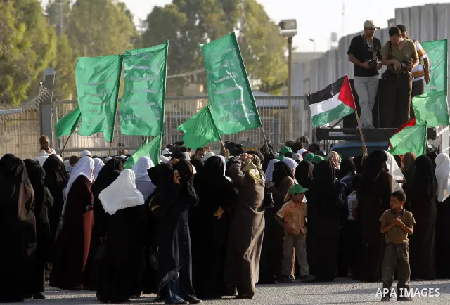 Palestinian supporters of Hamas shout slogans during a protest against the Israeli blockade near the Rafah border crossing in the southern Gaza Strip on July5, 2009. Israel has sealed Gaza off from all but vital humanita...