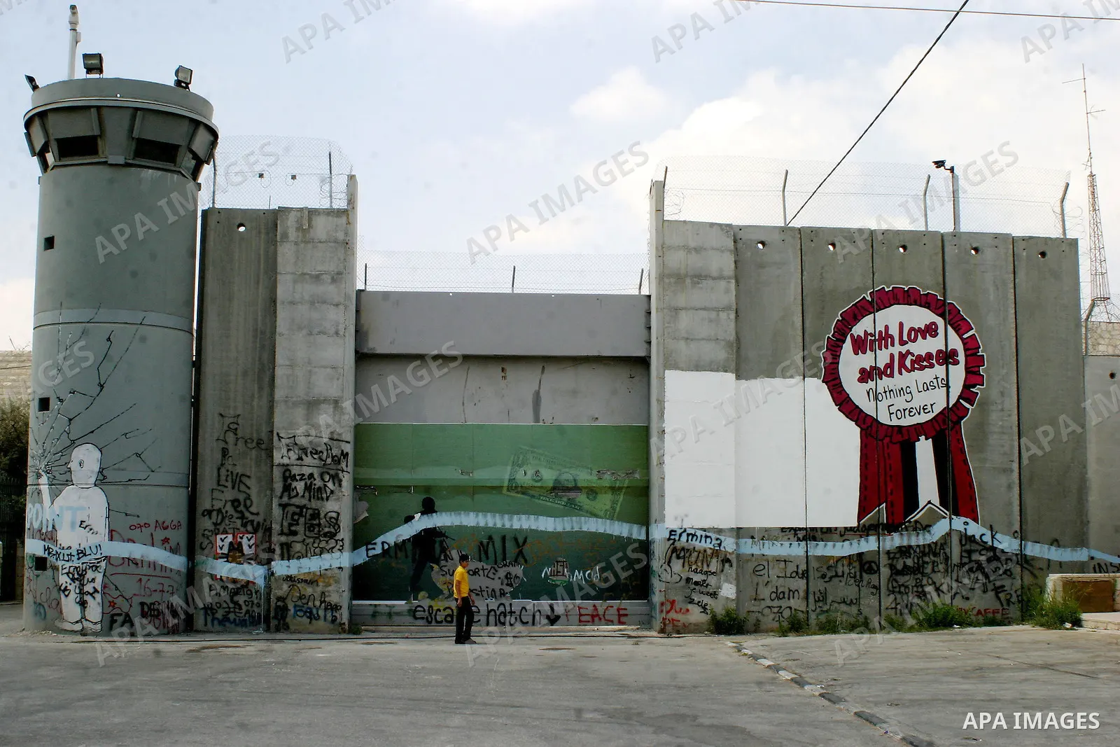 Palestinian boys walk beside the controversial Israeli barrier in the West Bank town of Bethlehem on July 6 2009. Photo by Najeh Hashlamoun
