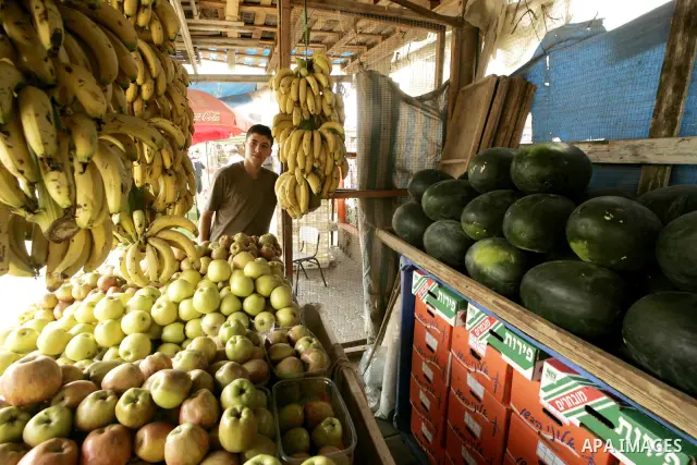A Palestinian sells fruits at a popular market in Khan Younis in southern Gaza on July 6, 2009. Hamas trying to cultivate a different crops to satisfy the local demand due to the Israeli blockade, the agriculture ministr...