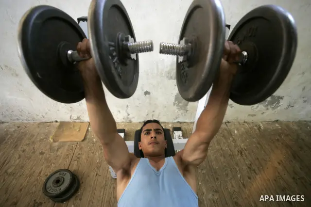 A Palestinian young men playing in a hall of iron club in Rafah the southern Gaza Strip on July 8,2009. Palestinian delegation left the Athletics on Sunday evening, the Gaza Strip through the Rafah border crossing to par...