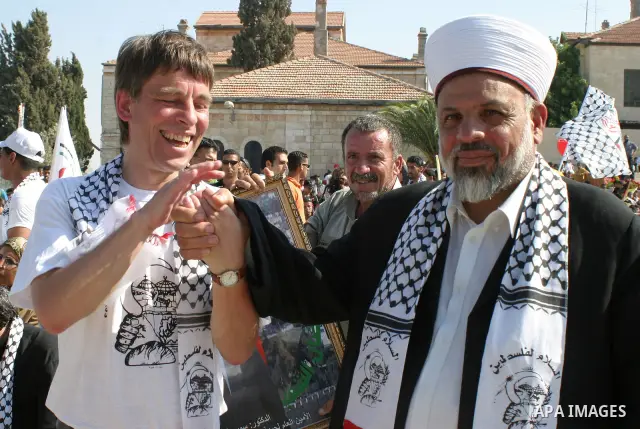 Palestinian Sheikh Tayssir Tamimi and Mathias Bettenhauser a Mayor in Jena town in Germany during a demonstration against Israel's controversial separation barrier in the West Bank town of Beit Jala near Bethlehem during...