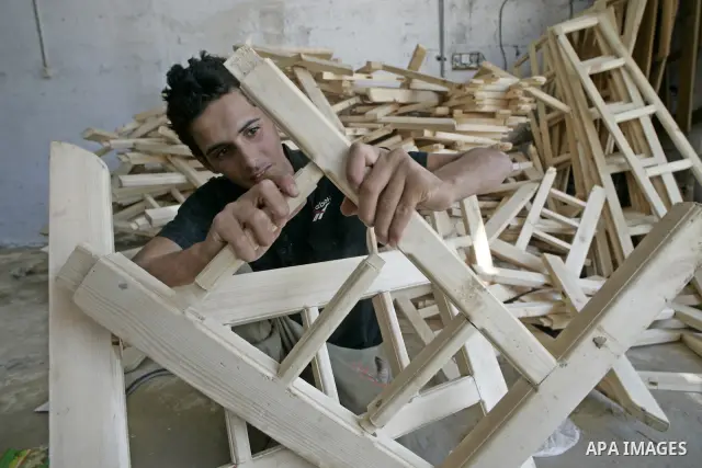 A Palestinian carpenter working in a wood workshop in Rafah the southern Gaza Strip on July 18, 2009. Palestinian merchants are dependent on goods smuggled through tunnels under the land between Egypt and Gaza due to the...