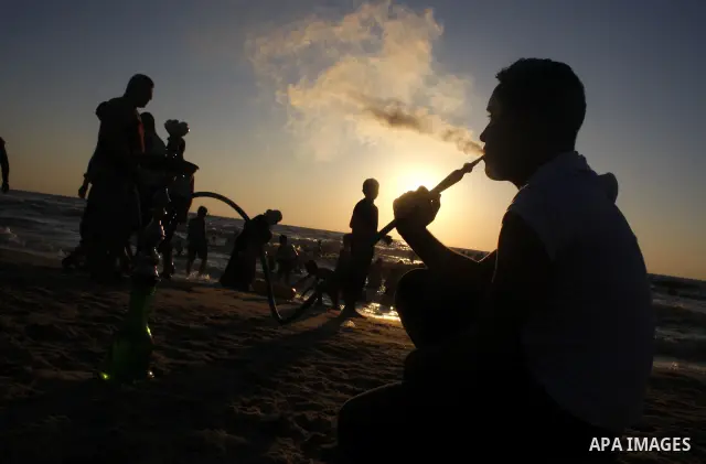 Palestinians enjoy a day on the beach of Gaza sea on July 18, 2009. Some 100,000 Palestinian youths are attending various camps during the summer holiday with activities ranging from religious lessons to swimming, horseb...