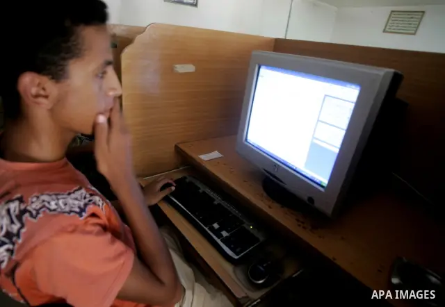 A Palestinian students examine results of the general secondary on Internet Web in Rafah southern Gaza Strip on July 21, 2009. Photo By Abed Rahim Khatib