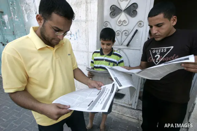 A Palestinian students examine results of the general secondary on Gazette in Rafah southern Gaza Strip on July 21, 2009. Photo By Abed Rahim Khatib