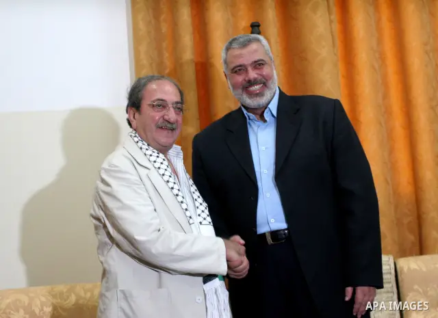 Palestinian Prime Minister of Hamas Ismail Haniya receives the Syrian artist Dureid Lahham in Gaza city on July 25, 2009. Photo By Mohammed Asad