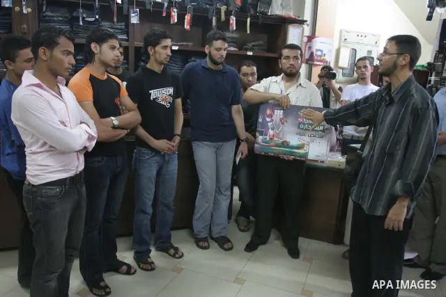 Palestinian youths distributing posters calling for the commitment of the Islamic Shariah, the Islamic dress, the veil and the rejection of nudity and porn sites and drugs during El-Fadila campaign organized by of the Mi...