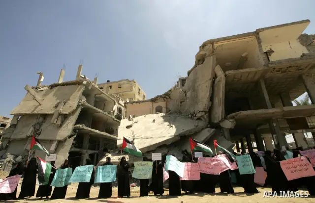 A Palestinians hold a placards and their national flag during a demonstration in Rafah southern Gaza Strip on July 29, 2009. The demonstration calling for reconciliation between Palestinian factions Hamas and Fatah And d...